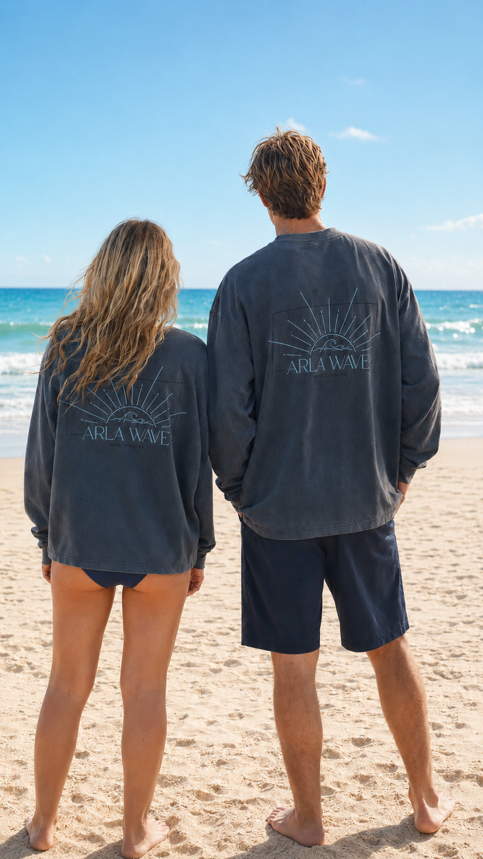 Arla Wave navy oversized long sleeve shirt back view on two different gender models, large light blue logo with sun and waves