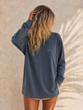 Arla Wave navy oversized long sleeve shirt front view, small light blue wave logo on left side of feminine models chest